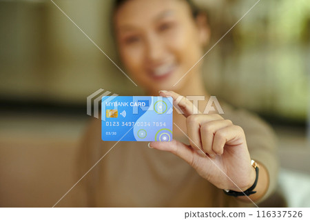 Woman Demonstrating Her Plastic Card 116337526