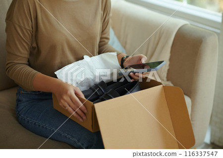 Woman Opening Box With Shoes Of Small Size Woman Opening Box With Shoes Of Small Size 116337547