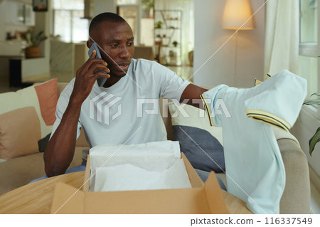 Man Making Phone Call To Solve Problem With Order Man Making Phone Call To Solve Problem With Order 116337549