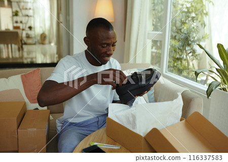 Man Opening Box With New Shoes Man Opening Box With New Shoes 116337583