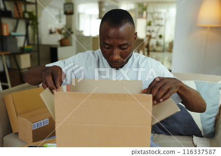 Man Opening Box With Good 116337587