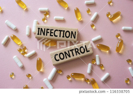 Infection Control symbol. Concept word. Infection Control on wooden blocks. Beautiful pink background with pills. Medicine and Infection Control concept. Copy space 116338705