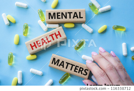 Mental Health Matters symbol. Concept words Mental Health Matters on wooden blocks. Beautiful blue background with pills. Doctor hand. Healthcare and Mental Health Matters concept. Copy space. Mental Health Matters symbol. Concept words Mental Health Matters on wooden blocks. Beautiful blue background with pills. Doctor hand. Healthcare and Mental Health Matters concept. Copy space. 116338712