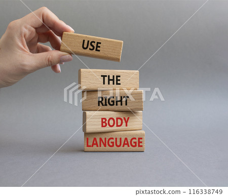 Use the right Body Language symbol. Concept words Use the right Body Language on wooden blocks. Businessman hand. Beautiful grey background. Business concept. Copy space 116338749