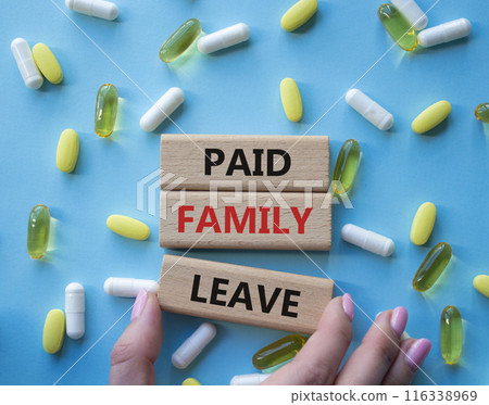 Paid Family Leave symbol. Concept words Paid Family Leave on wooden blocks. Beautiful blue background with pills. Doctor hand. Healthcare and Paid Family Leave concept. Copy space. 116338969