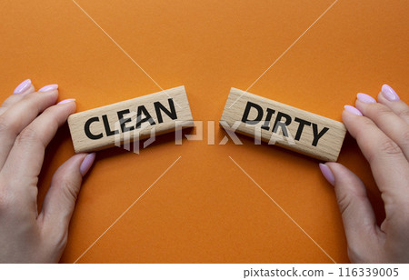 Clean or Dirty symbol. Concept word Clean or Dirty on wooden blocks. Man hand. Beautiful orange background. Gender and Clean or Dirty concept. Copy space 116339005
