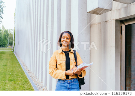 African American woman student smiling confident hold exercise books and backpack, Education, school and people concept. 116339173