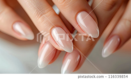 a close-up view of manicured fingernails with a glossy, natural finish 116339854