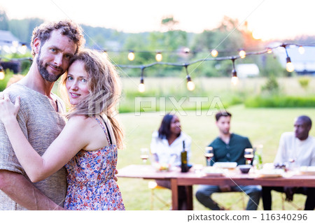 Enjoy a summer party with friends in a cozy backyard filled with warmth, laughter, and joy 116340296