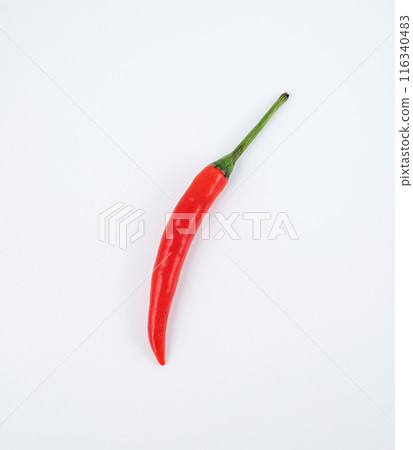 One red hot chili peppers on a white background close-up. Gop view and copy space One red hot chili peppers on a white background close-up. Gop view and copy space 116340483