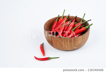 Red hot chili pepper in a wooden bowl on a white background close-up. Copy space 116340486