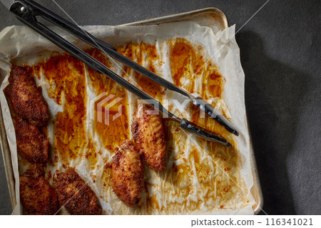 closeup of baked crispy chicken wings 116341021