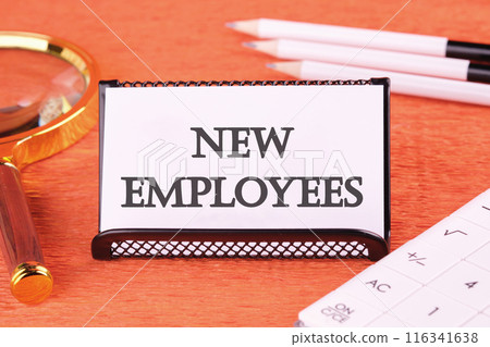 NEW EMPLOYEES word written on a white business card on an orange background NEW EMPLOYEES word written on a white business card on an orange background 116341638