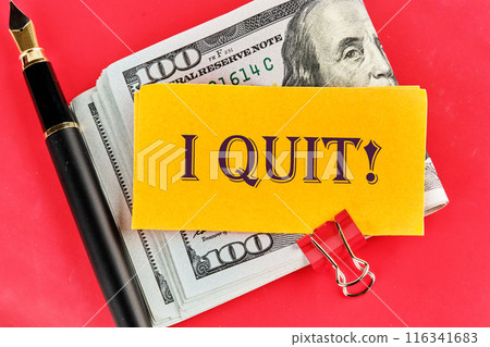 I Quit word on a yellow piece of paper on dollars on a red background I Quit word on a yellow piece of paper on dollars on a red background 116341683