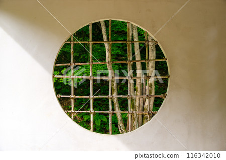 Round window of an old folk house 116342010