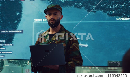 Army general managing air traffic control for military aircraft within the operational area, uses radar surveillance. Follows vessels on navy reconnaissance satellite system, big screen. Camera A. Army general managing air traffic control for military aircraft within the operational area, uses radar surveillance. Follows vessels on navy reconnaissance satellite system, big screen. Camera A. 116342323