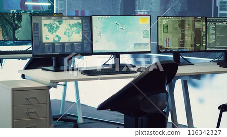 Empty military drone control center employing surveillance radar footage to follow satellite and ensure national protection. Army intelligence and reconnaissance system in headquarters. Empty military drone control center employing surveillance radar footage to follow satellite and ensure national protection. Army intelligence and reconnaissance system in headquarters. 116342327