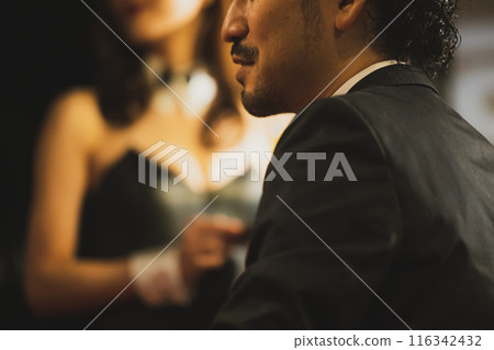 A man drinking at a bar and a bunny girl A man drinking at a bar and a bunny girl 116342432