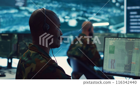 Military personnel execute electronic intelligence gathering missions to intercept enemy communications or warships gps positions. Soldiers conducting reconnaissance operations. Camera A. Military personnel execute electronic intelligence gathering missions to intercept enemy communications or warships gps positions. Soldiers conducting reconnaissance operations. Camera A. 116342440
