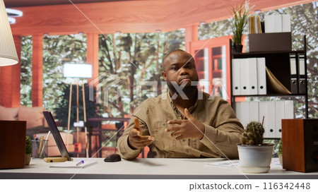 POV of businessman discussing the annual report with investors via videocall, showcasing market analysis from laptop at home. Entrepreneur working to obtain insurance funds. Camera B. POV of businessman discussing the annual report with investors via videocall, showcasing market analysis from laptop at home. Entrepreneur working to obtain insurance funds. Camera B. 116342448