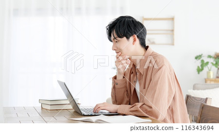 A man thinking at a computer A man thinking at a computer 116343694