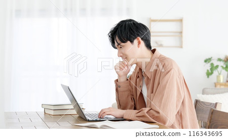 A man thinking at a computer A man thinking at a computer 116343695