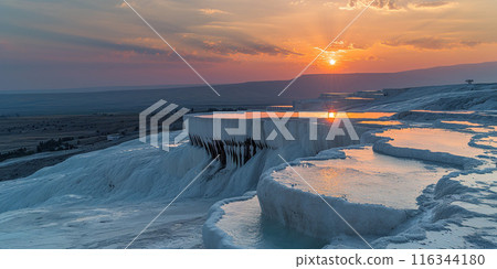 Mineral rich baby blue thermal waters in white travertine terraces on a hillside in Pamukkale, Turkey. Sunset outdoors spa in nature, travel destination, relaxation and calmness landscape 116344180
