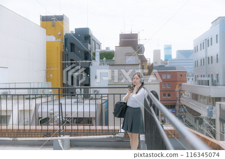 High school girl listening to music on the roof High school girl listening to music on the roof 116345074