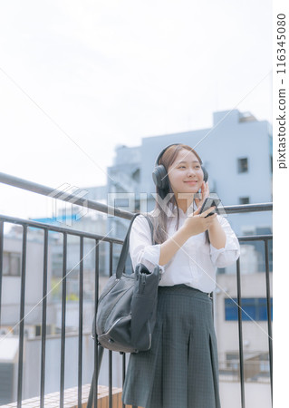 High school girl listening to music on the roof 116345080