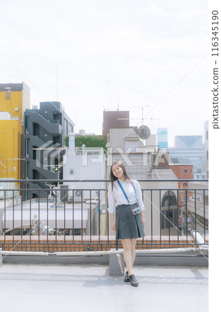 High school girl using a film camera 116345190