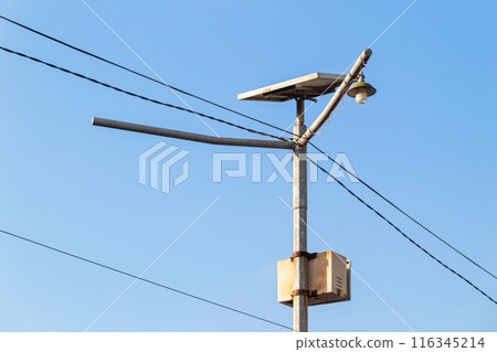 metal pole with common lights and cables with sky background 116345214
