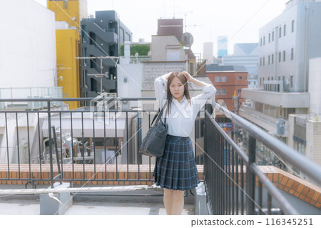 School girls standing on the roof 116345251