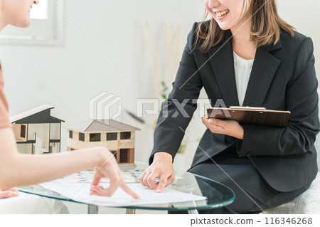 An Asian woman consulting with a businesswoman who explains and sells home ownership, real estate, renovations, and asset management An Asian woman consulting with a businesswoman who explains and sells home ownership, real estate, renovations, and asset management 116346268