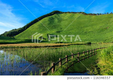 Evening scenery of the Soni Plateau in the summer of 2024. Mount Kuruson with its beautiful mountainside bathed in the setting sun and Okame Pond filled with abundant water. Horizontal composition ① Evening scenery of the Soni Plateau in the summer of 2024. Mount Kuruson with its beautiful mountainside bathed in the setting sun and Okame Pond filled with abundant water. Horizontal composition ① 116346557