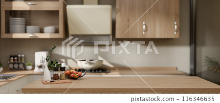 A copy space for displaying products on a wooden kitchen island in a contemporary minimalist kitchen A copy space for displaying products on a wooden kitchen island in a contemporary minimalist kitchen 116346635