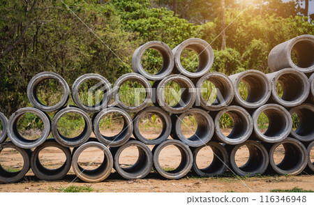 A stack of concrete ring pipes piled and creating a symmetrical arrangement 116346948