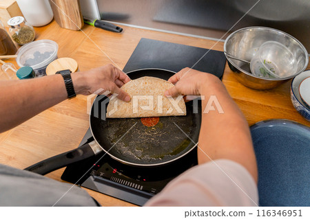 Chef at the kitchen preparing quesadillas with tofu and sweet corn 116346951