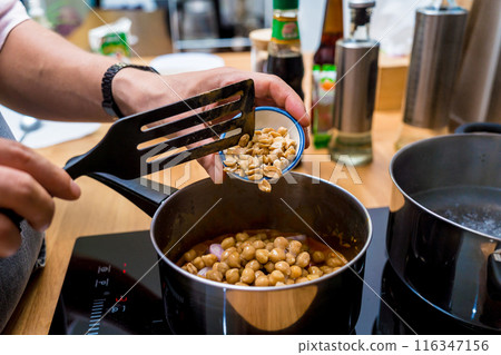 Chef at the kitchen preparing massaman curry with sweet potato and many spices Chef at the kitchen preparing massaman curry with sweet potato and many spices 116347156