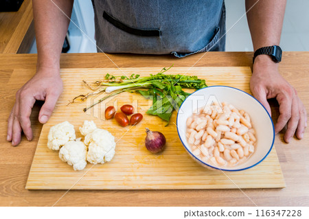 Cutting board with ingredients for preparing bean porridge with cauliflower and vegetables 116347228
