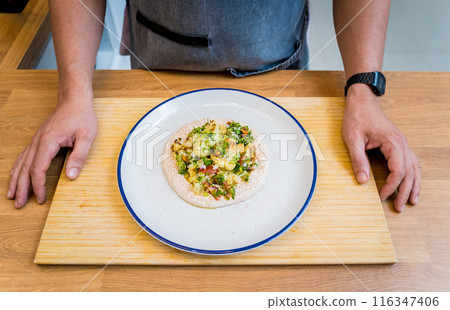 Chef at the kitchen preparing bean porridge with cauliflower and vegetables Chef at the kitchen preparing bean porridge with cauliflower and vegetables 116347406