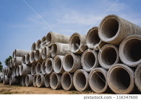 A stack of concrete ring pipes piled and creating a symmetrical arrangement A stack of concrete ring pipes piled and creating a symmetrical arrangement 116347600