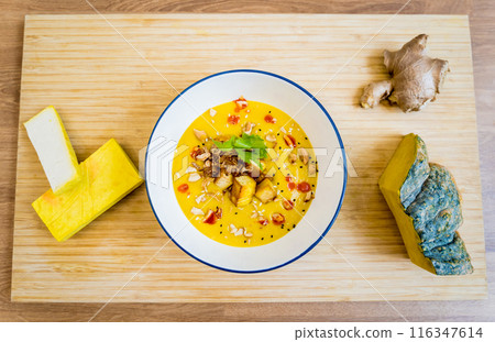 A bowl of pumpkin porridge with tofu and vegetables A bowl of pumpkin porridge with tofu and vegetables 116347614