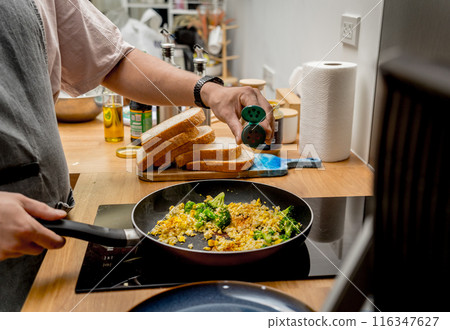 Chef at the kitchen preparing tofu scramble with vegetables Chef at the kitchen preparing tofu scramble with vegetables 116347627