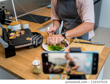 The chef is broadcasting live from workshop how to prepare a grilled eggplants with garlic 116347629