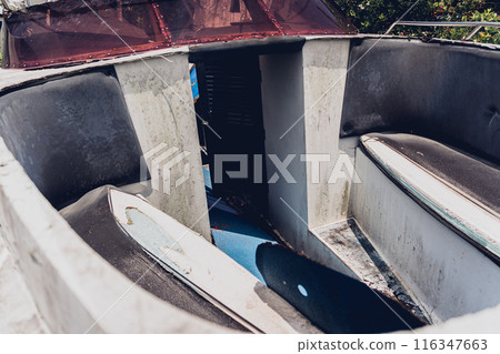Old and rusty motor boats on a landfill surrounded by tropical forest 116347663