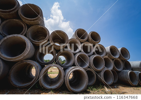A stack of concrete ring pipes piled and creating a symmetrical arrangement A stack of concrete ring pipes piled and creating a symmetrical arrangement 116347668
