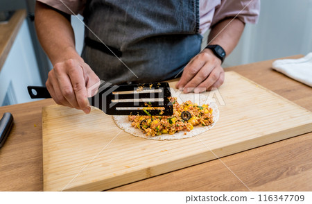 Chef at the kitchen preparing quesadillas with tofu and sweet corn Chef at the kitchen preparing quesadillas with tofu and sweet corn 116347709