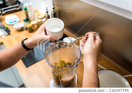Chef at the kitchen preparing chickpea porridge with ginger 116347795