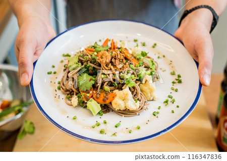 Japanese buckwheat pasta with lentils and vegetables in a bowl 116347836