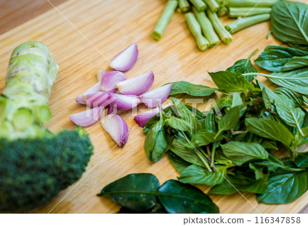 Cutting board with ingredients for preparing green curry with herbs and rice Cutting board with ingredients for preparing green curry with herbs and rice 116347858